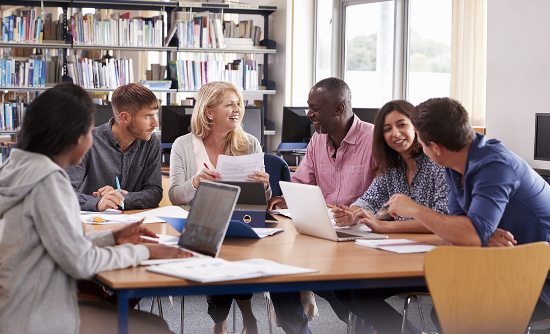 Adults talking and working together around a table