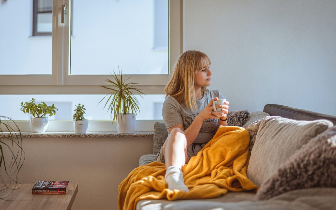 A woman drinking coffee in a warm home