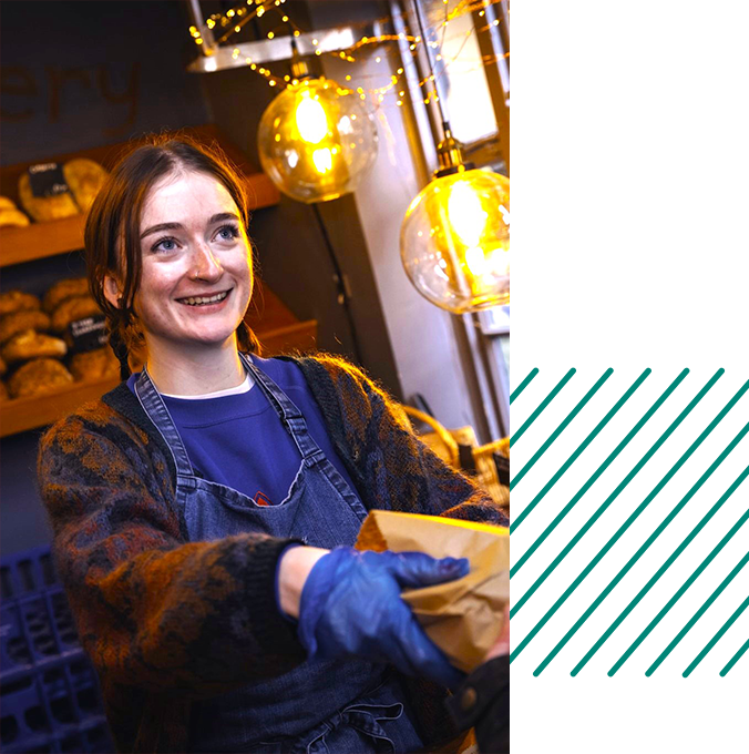 Woman serving a customer in a shop