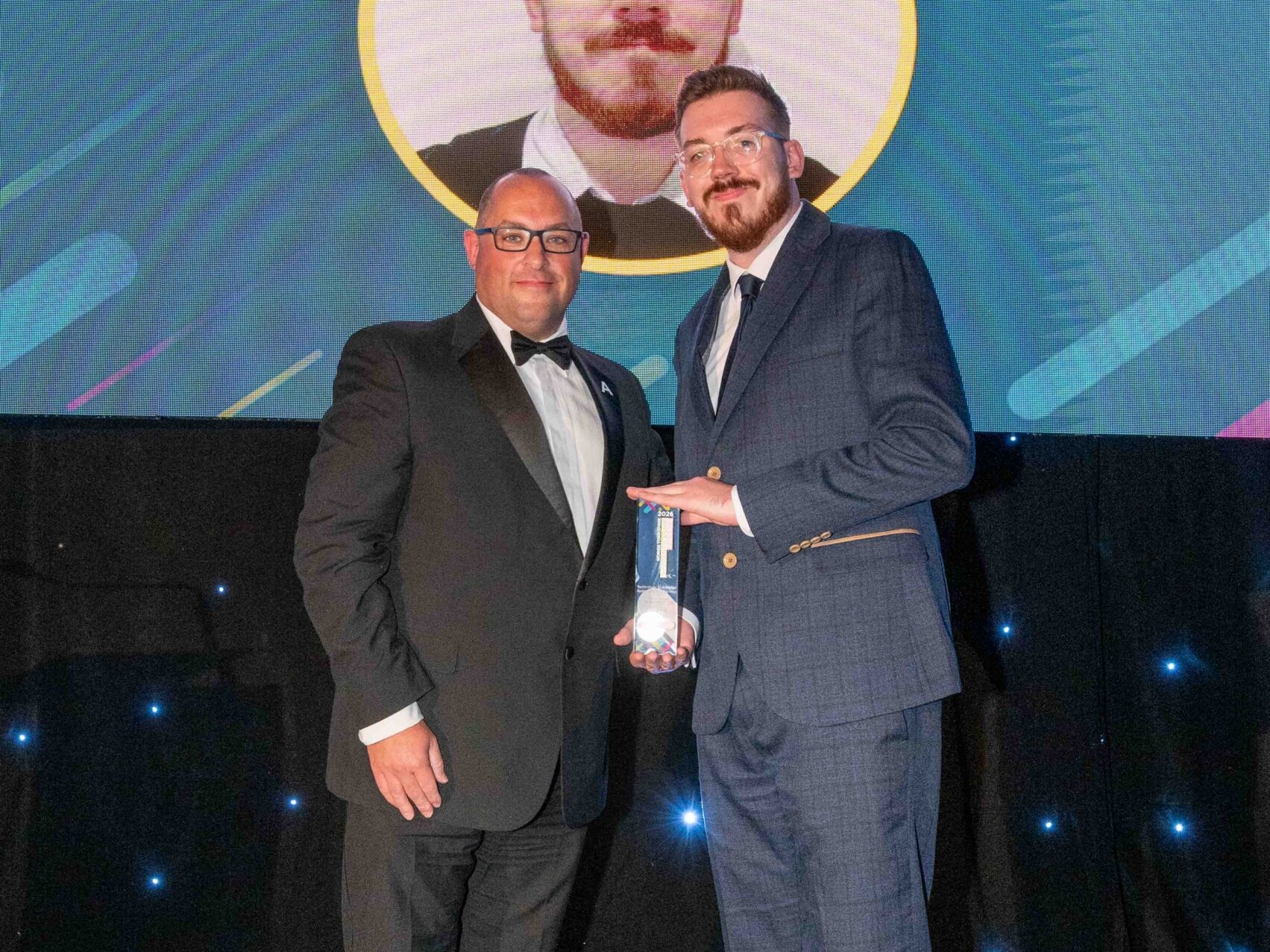 Kieran Graham receives apprentice award landscape left: Thomas Burton, Head of Apprenticeship Delivery at York St John University presents Kieran Graham with the Technology and Digital Apprentice of the Year award.