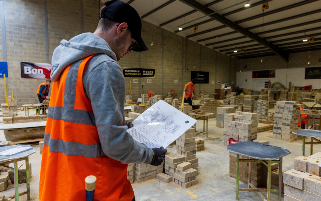 A student learning bricklaying in a college classroom