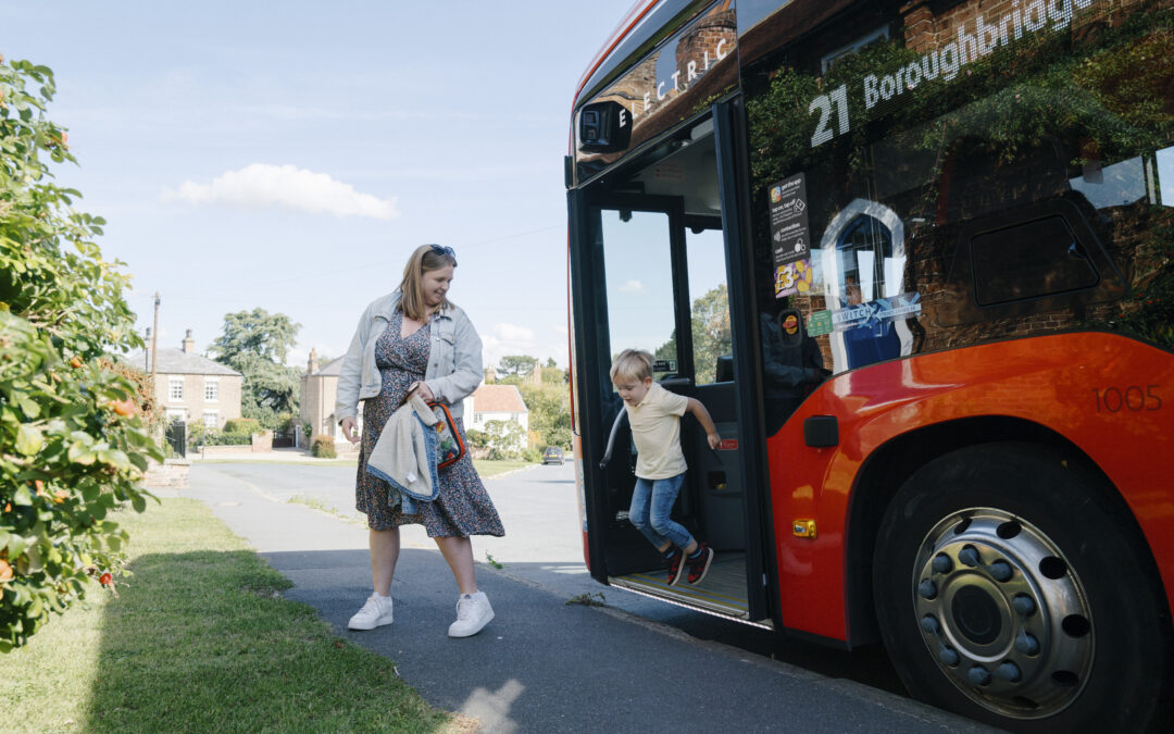 Mother and son jumping off a bus in Boroughbridge, North Yorkshire