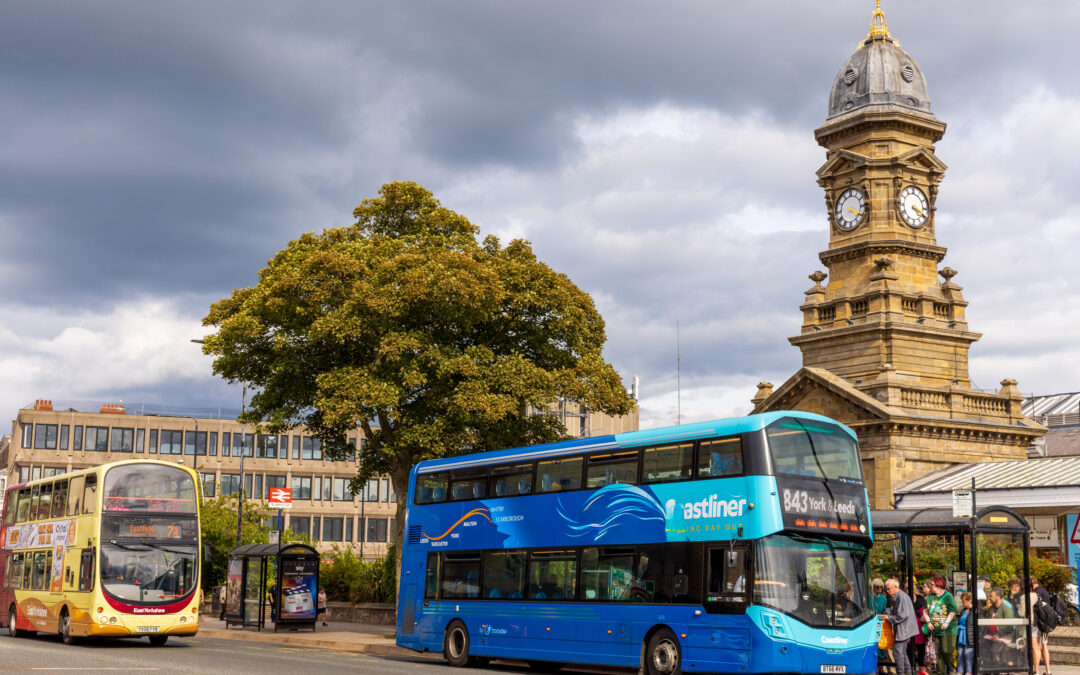Two buses in a town centre