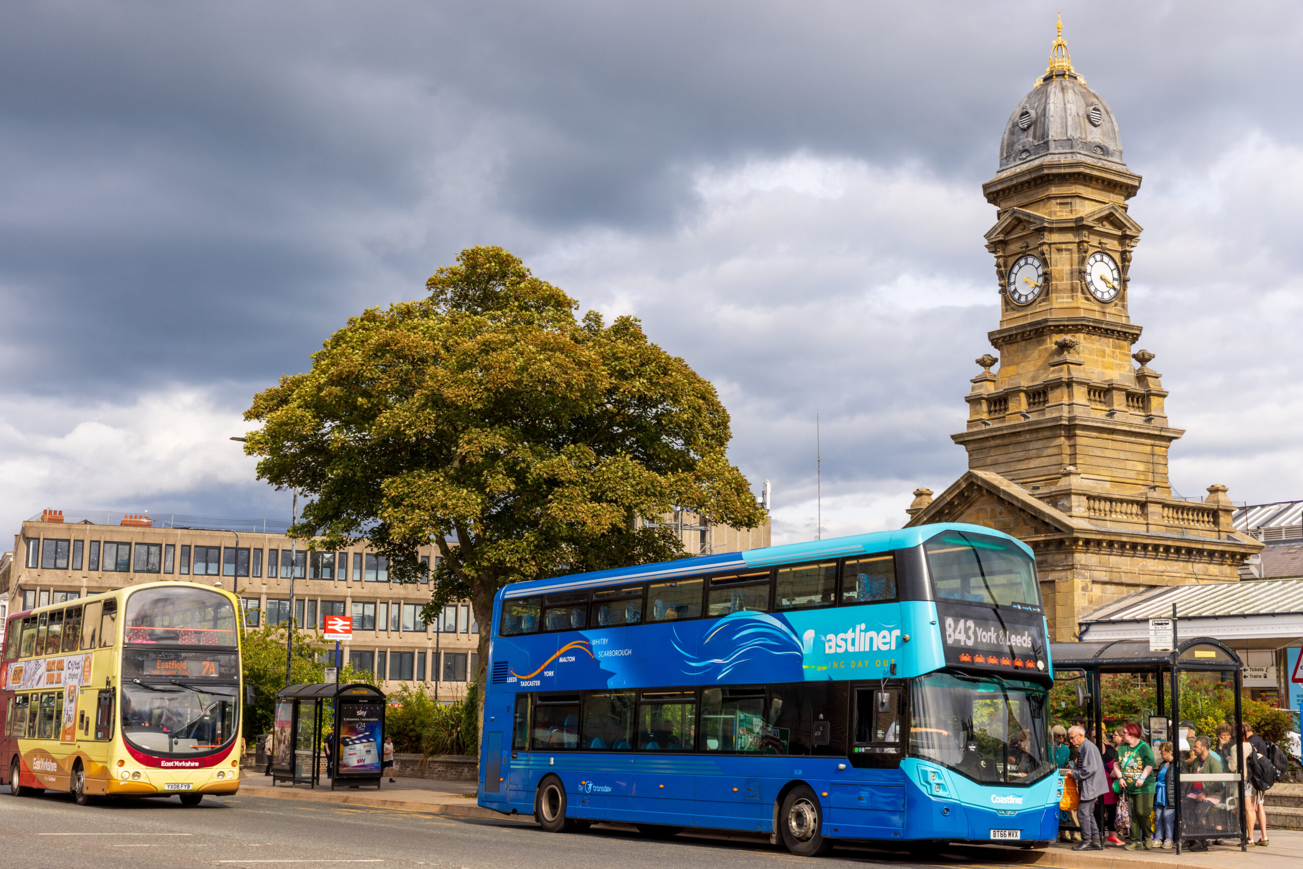 Two buses in a town centre